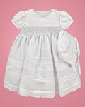 Vestido de bautizo blanco con nido de abeja y gorrito para bebé niña, vista de frente | JR Baby Center