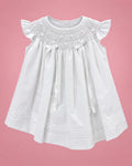 Vestido de bautizo blanco con nido de abeja y lazos de cinta para bebé niña, vista de frente | JR Baby Center
