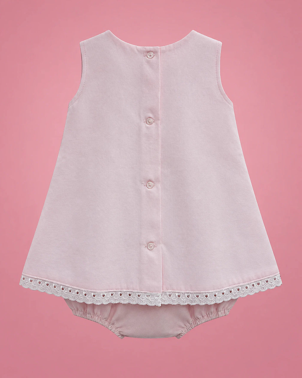 Vestido rosado con panel blanco, lacitos y bombacho para bebé niña, vista de espalda con bombacho | JR Baby Center