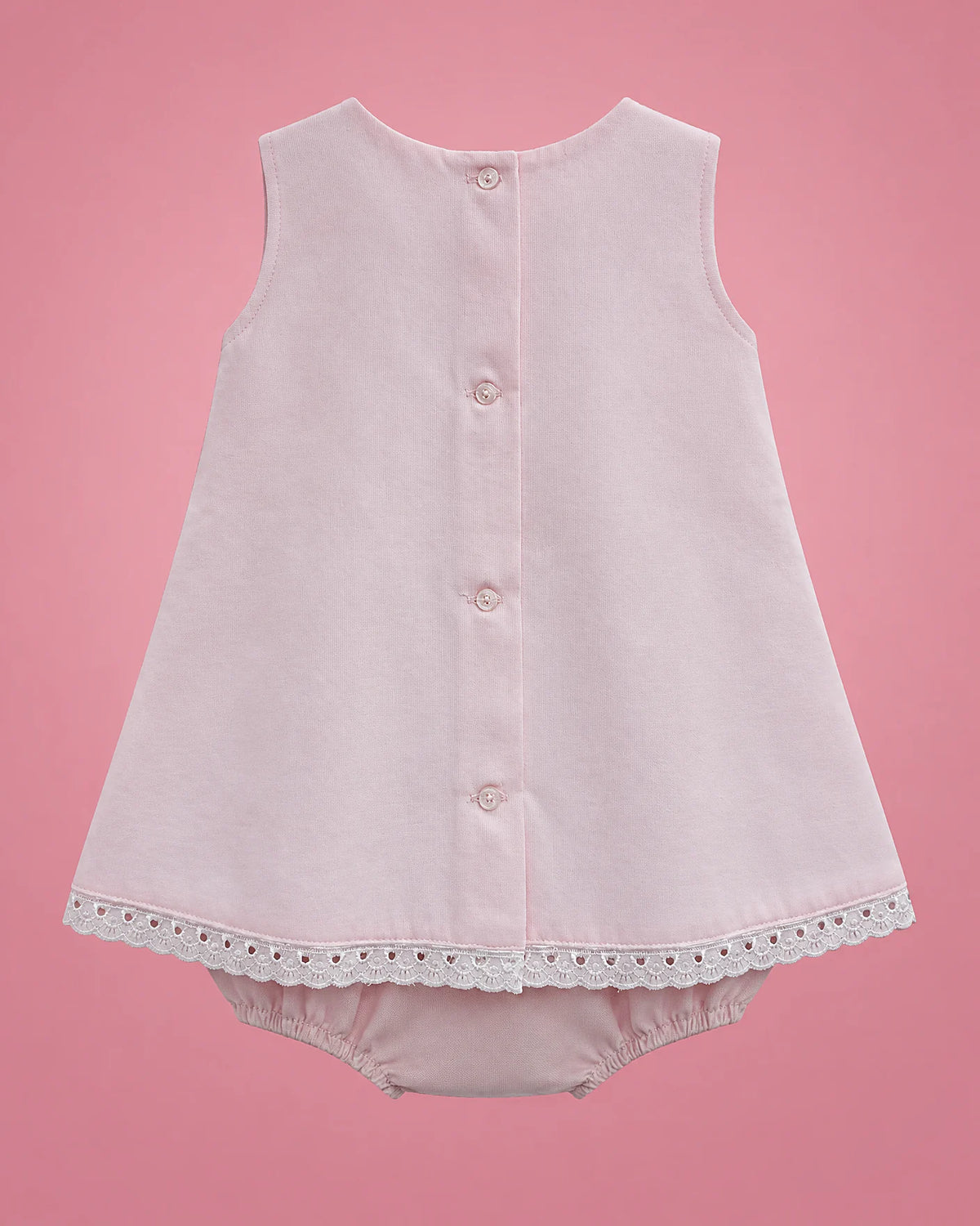 Vestido rosado con panel blanco, lacitos y bombacho para bebé niña, vista de espalda con bombacho | JR Baby Center