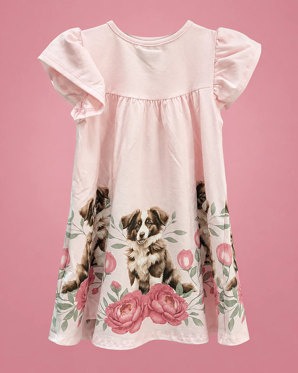 Vestido rosa con perritos y rosas en el borde para niña, vista de espalda | JR Baby Center
