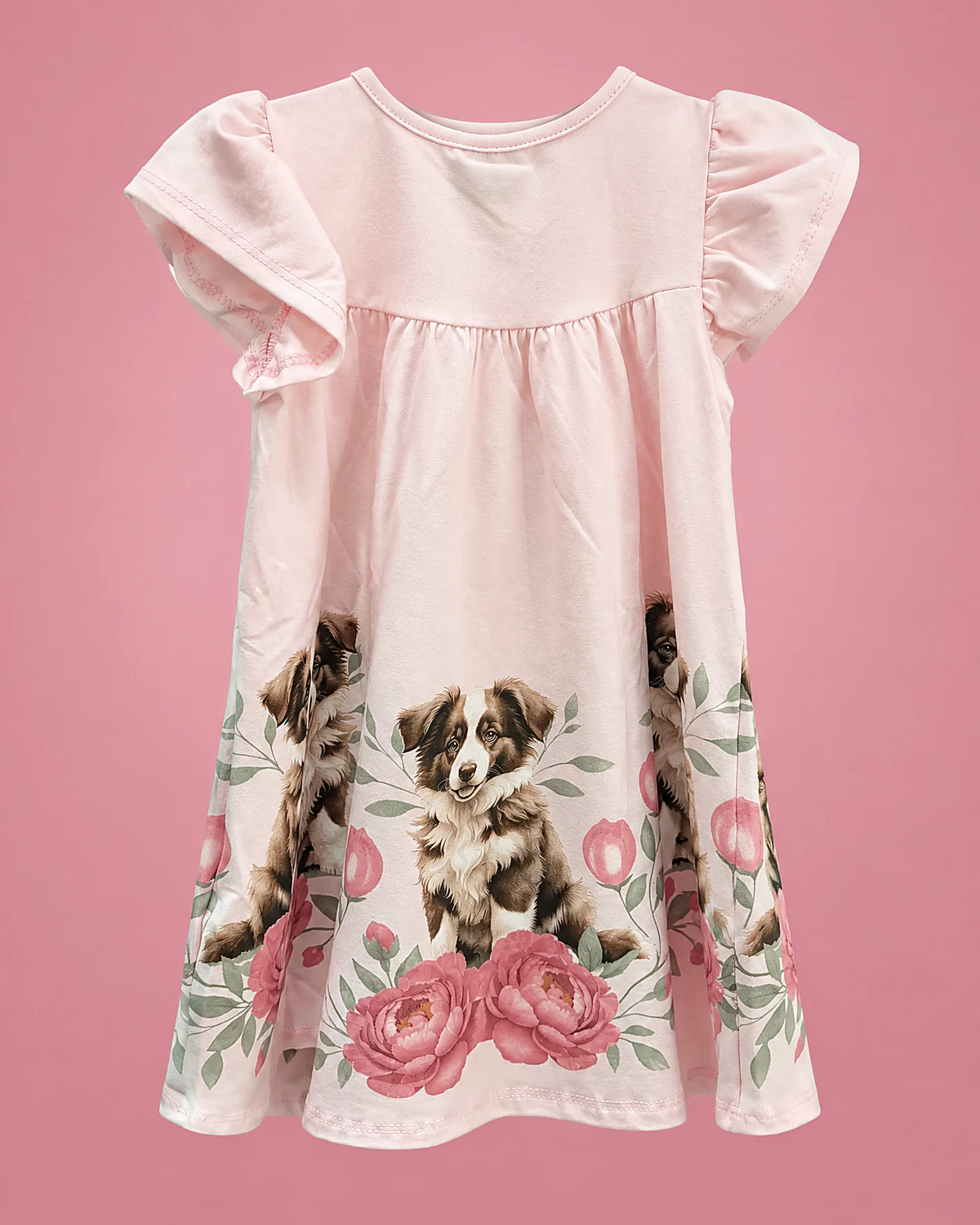 Vestido rosa con perritos y rosas en el borde para niña, vista de espalda | JR Baby Center