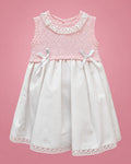 Vestido sin mangas rosado y blanco con lacitos y encaje para bebé niña, vista de frente | JR Baby Center