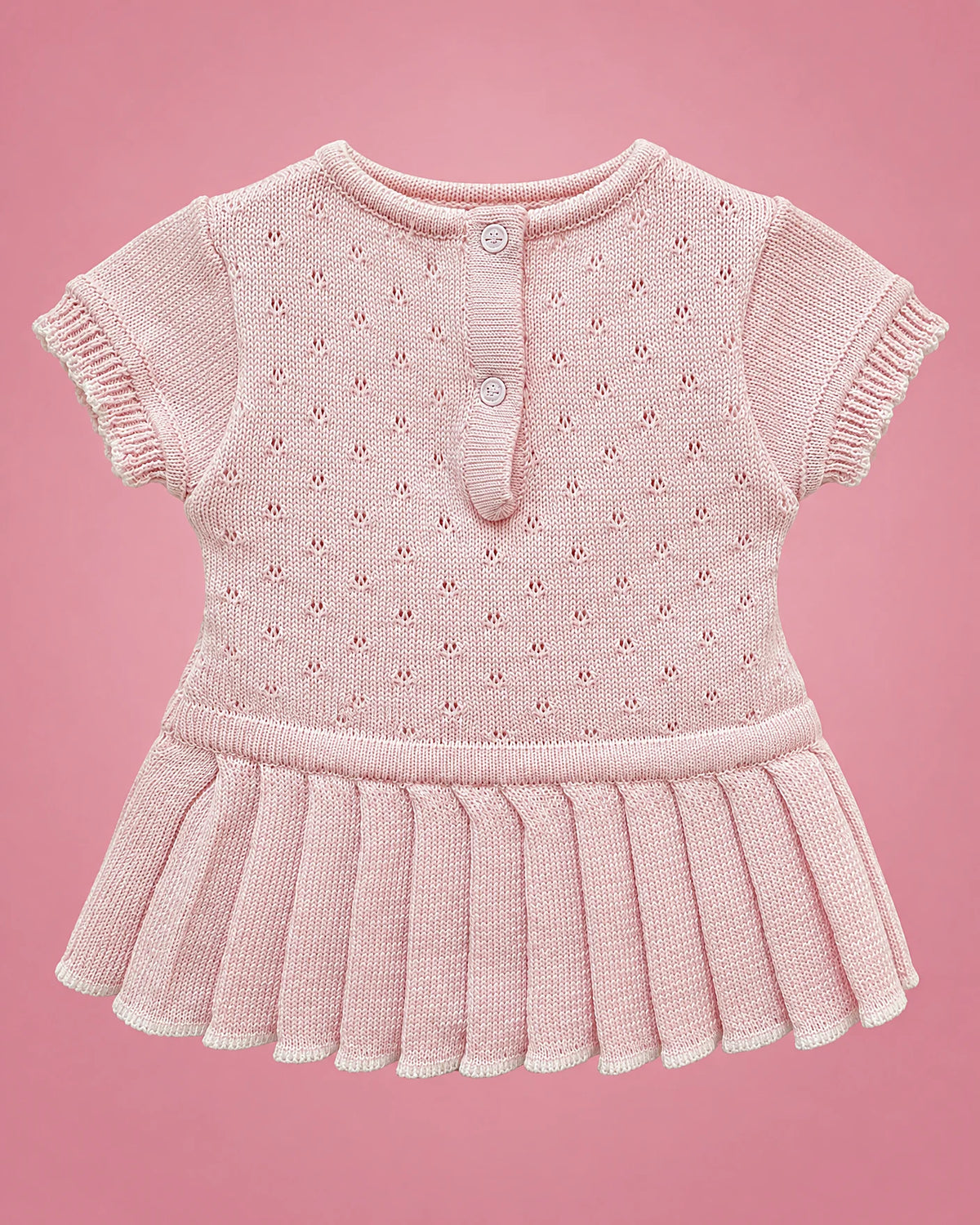 Vestido rosado con calados, falda plisada y lacito crema para bebé niña, vista de espalda | JR Baby Center